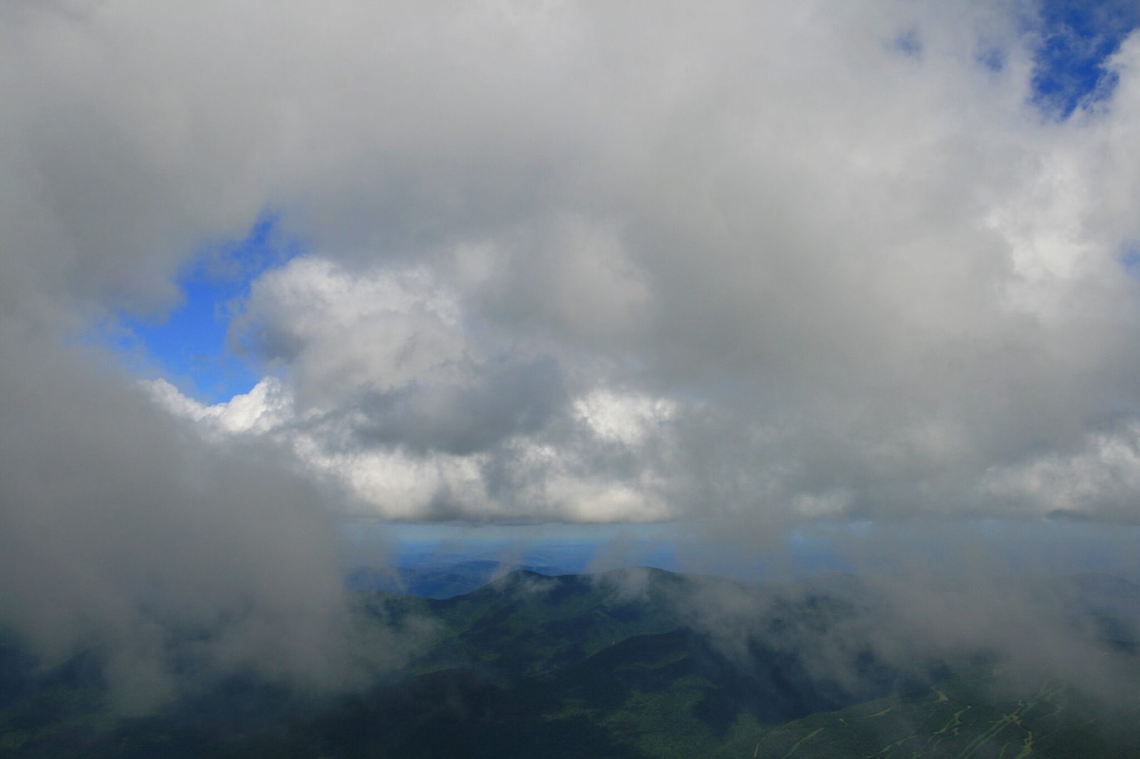 Layered mountains and dramatic summer sky from the summit of Mount Washington in New Hampshire