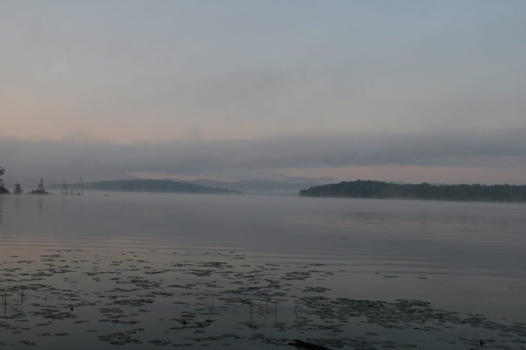 Soft morning light and mist over Lake Umbagog National Wildlife Refuge with distant islands