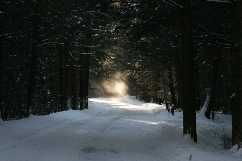 Wind‑lifted swirl of snow rising like an angel in soft winter light at Bigelow Hollow State Park in Union, Connecticut, peaceful nature photograph