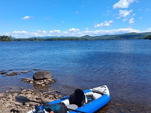 Sea Eagle Explorer kayak pulled onto the shore of a remote island on Lake Umbagog.